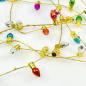 Preview: Geschenkband, Faux light Kordel in gold mit farbigen kleinen Tannenbaumlichter